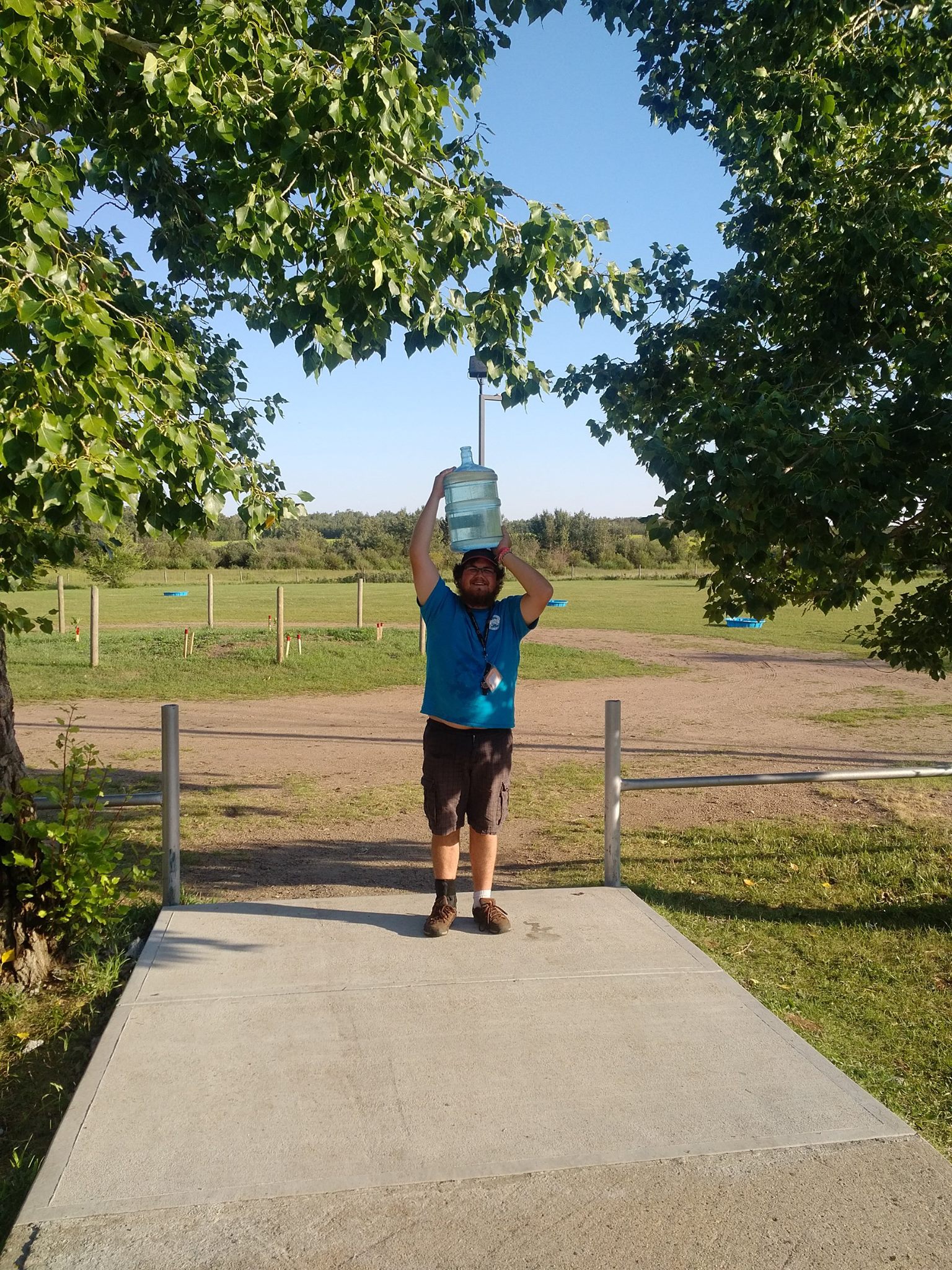 person carrying a water jug